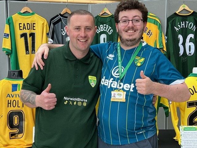 Two visitors giving thumbs up in front of the On the Stall City stand at the March 2024 Football Collectors Fair